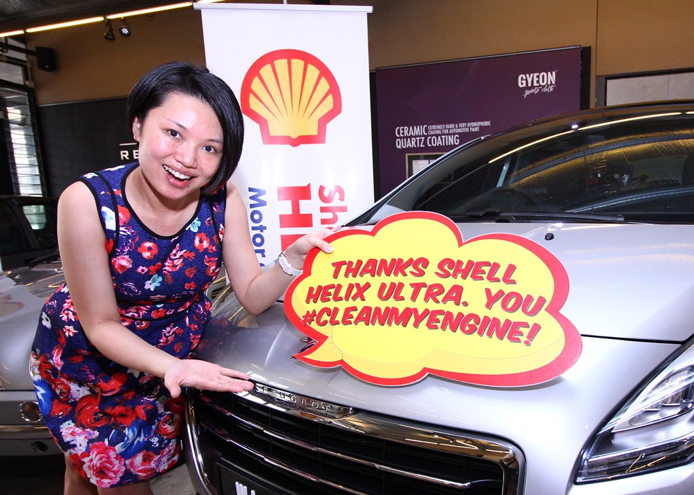 A radiant Mrs K'ng Choo Wei and her family's shiny Peugeot SUV_2