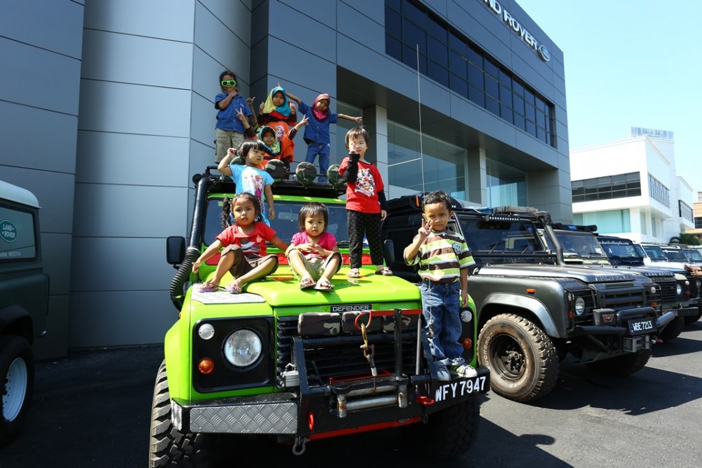 Adorable children in colourful clothes matched this colourful Land Rover Defender 110 Wagon perfectly