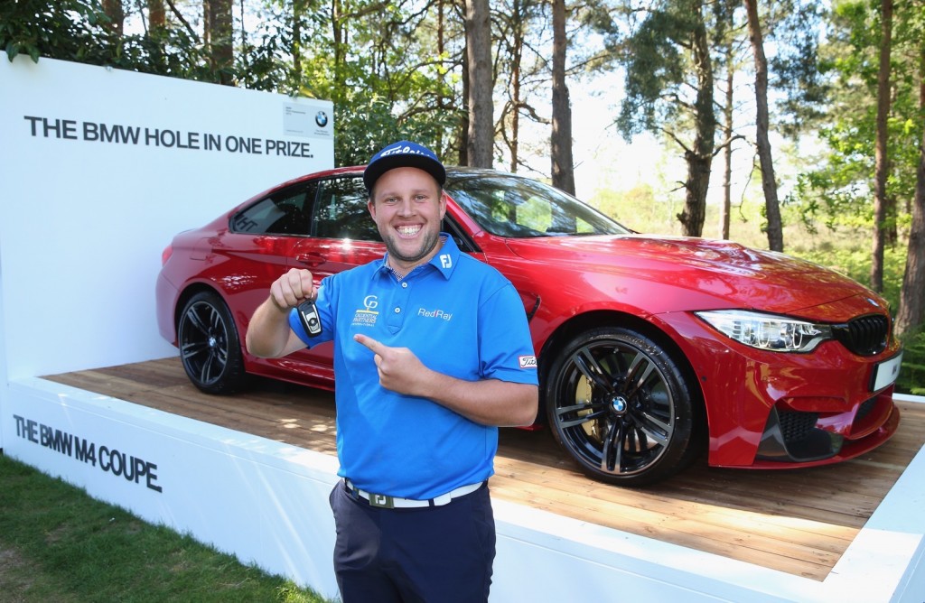 VIRGINIA WATER, ENGLAND - MAY 21:  Andrew Johnston of England poses with the keys to his new BMW M4 Coupe after his hole-in-one on the 10th hole during day 1 of the BMW PGA Championship at Wentworth on May 21, 2015 in Virginia Water, England.  (Photo by Andrew Redington/Getty Images)