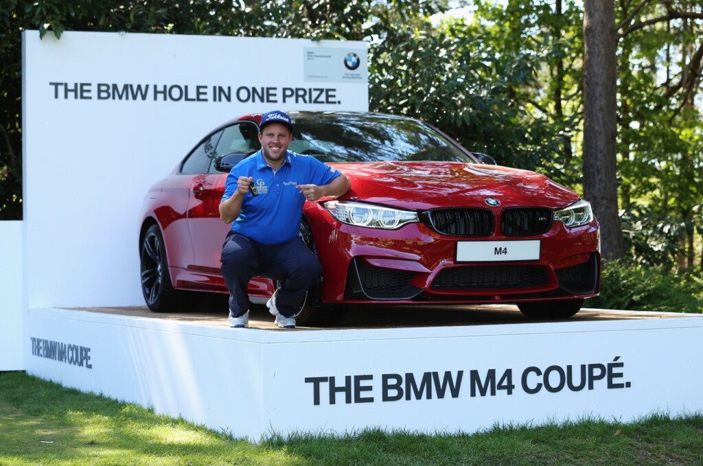 VIRGINIA WATER, ENGLAND - MAY 21:  Andrew Johnston of England poses with the keys to his new BMW M4 Coupe after his hole-in-one on the 10th hole during day 1 of the BMW PGA Championship at Wentworth on May 21, 2015 in Virginia Water, England.  (Photo by Andrew Redington/Getty Images)