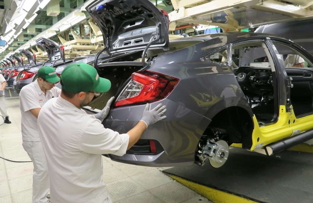 Honda of Canada Mfg. associates install a rear bumper fascia on a 2016 Civic Honda Civic Sedan.