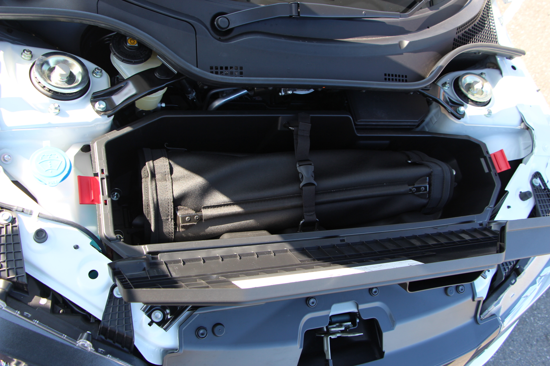 Rag-top detaches completely and rolls-up into the front 'boot' space...