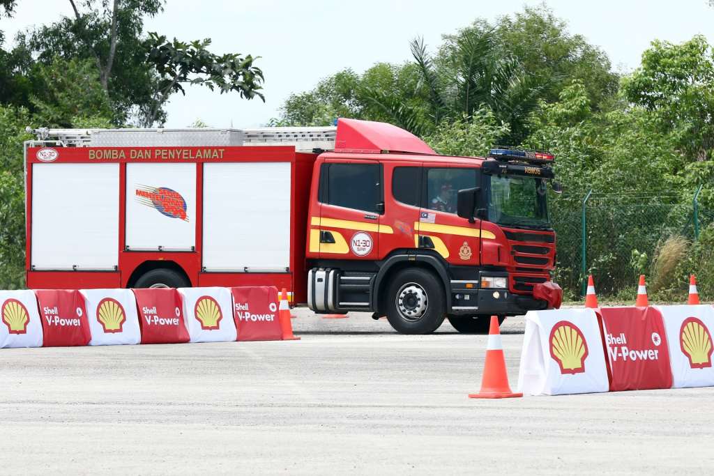 6. Scuderia Ferrari driver Kimi Räikkönen behind the wheels of a fire truck for the Shell V-Power Job Swap