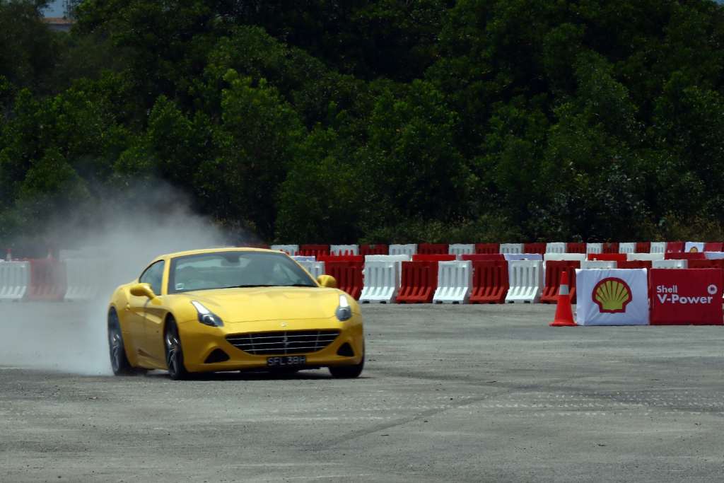 8. As part of the Shell V-Power Job Swap,Scuderia Ferrari driver Kimi Räikkönen takes fireman Mohd Uzair Abdullah on a ride around the race track...