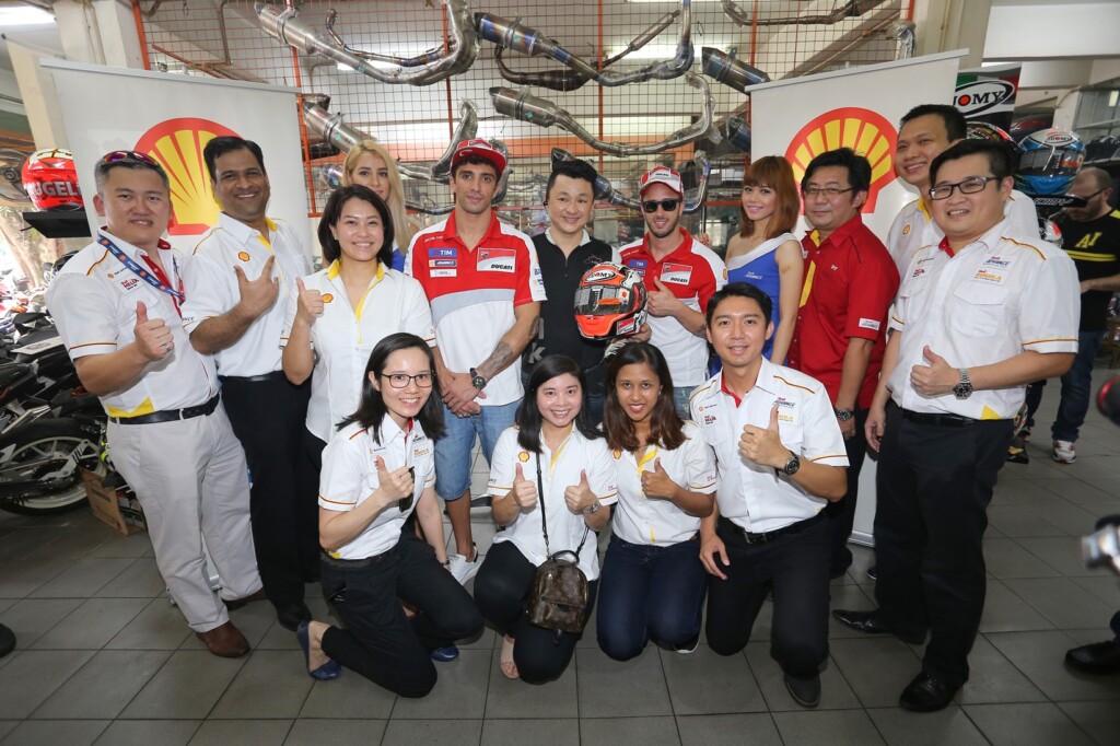 The Shell Lubricants team and Ducati riders posing with a happy workshop...