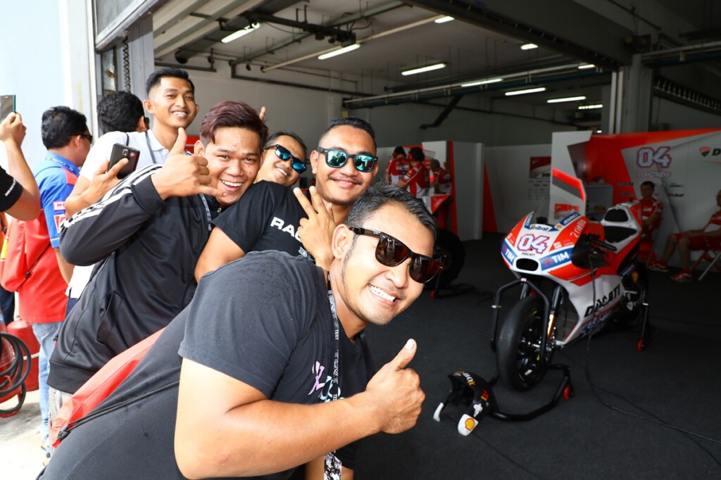 Lucky mechanics invited by Shell Advance pose at the Ducati garage
